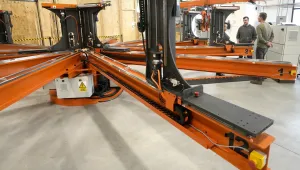 People stand near a magnet insulation wrapping machine at Commonwealth Fusion Systems, in Devens, Mass., Wednesday, Oct. 11, 2023.