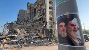 Posters of late Hezbollah leader Sayyed Hassan Nasrallah and the late Iranian revolutionary founder Ayatollah Khomeini, posted on a pole in front of a destroyed building in Beirut.