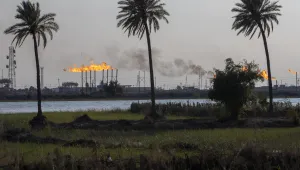 a landscape image of oil field flare stacks burning in Basra, Iraq