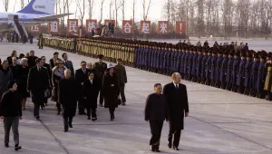 Escorted by Deng Xiao Ping, President Gerald Ford inspects the Honor Guard at Peking Capital Airport upon his arrival in China, December 1, 1975.