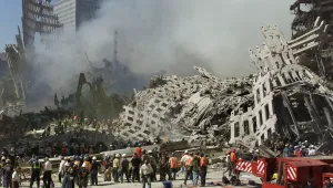In this Thursday, Sept. 13, 2001 file photo, rescue workers continue their search as smoke rises from the rubble of the World Trade Center in New York.