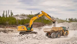 An excavator loads a dump truck with stone at Éléonore Mine in northern Quebec, May 18, 2023. 