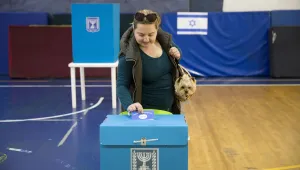 An Israeli woman casts her ballot for Israel's parliamentary election at a polling station in Ramat Gan, Israel, Tuesday, April 9, 2019