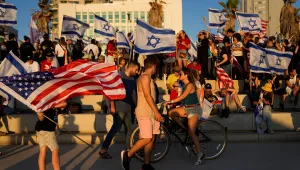 Demonstrators wave Israeli and U.S. flags