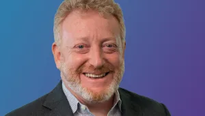 Headshot of Mark Brownstein against a blue gradient background.