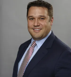 Jeremy Harrell, a middle-aged white man in a suit.