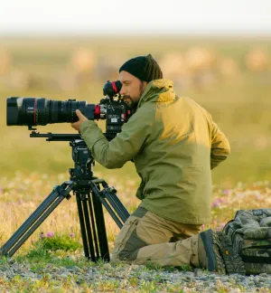 Florian Schulz kneels to take a photograph.