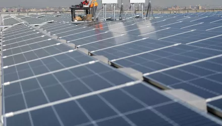 Electricians install solar panels.