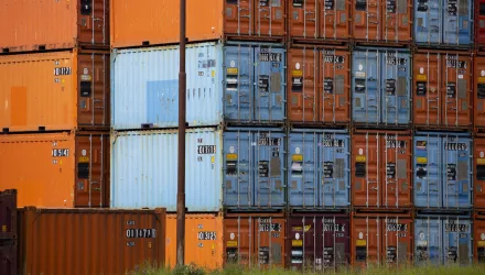 Orange and blue shipping containers in the port of Rotterdam, Netherlands.