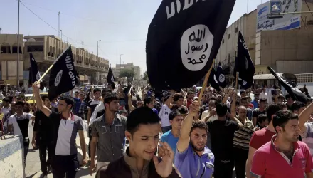 Demonstrators chant pro-Islamic State group slogans as they wave the group's flags in front of the provincial government headquarters in Mosul, 225 miles (360 kilometers) northwest of Baghdad, Iraq, Monday, June 16, 2014. 
