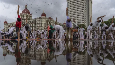 People perform Yoga to mark International Day of Yoga in front of Taj Mahal Palace hotel in Mumbai, India, Tuesday, June 21, 2022. Yoga enthusiasts across the world Tuesday took part in mass yoga events to mark Yoga Day. (AP Photo/Rafiq Maqbool)