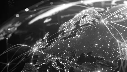 A black and white map with light beams connecting nations.