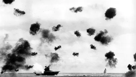 Smoke billows from the USS Yorktown and bursts from anti-aircraft fire fill the air after a Japanese bomber hit the aircraft carrier in the Battle of Midway near Midway Islands during World War II in June 1942.