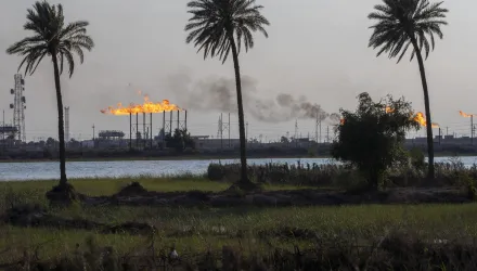 a landscape image of oil field flare stacks burning in Basra, Iraq
