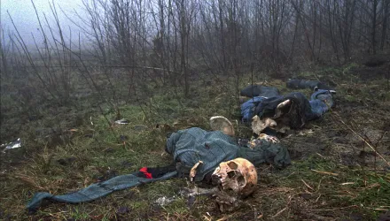 3.	 In this Feb. 4, 1996, file photo one of four clothed skeletons being examined by U.N. investigator Elizabeth Rehn as she tries identify an estimated 8,000 Muslim men missing after the Serb conquest of the former Muslim enclave of Srebrenica in July 1995, lies on a hilltop. 