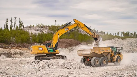 An excavator loads a dump truck with stone at Éléonore Mine in northern Quebec, May 18, 2023. 