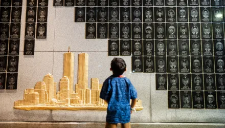 A young boy looks at the Brooklyn 9/11 Wall of Remembrance during the annual Candlelight Ceremony in Coney Island on the eve of the 25th anniversary of the Sept. 11 World Trade Center attacks, Thursday, Sept. 10, 2026, in New York. (AP Photo/Angelina Katsanis)