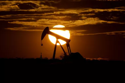 In this Wednesday, April 8, 2020, file photo, the sun sets behind an idle pump jack near Karnes City, Texas. Demand for oil continues to fall due to the new coronavirus outbreak. 