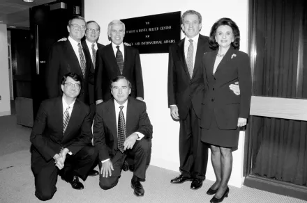 Ash Carter, Graham Allison, Robert and Renée Belfer, and Senators Sam Nunn, Richard Lugar, and Pete Domenici pose for a photo in front of the new Belfer Center sign.