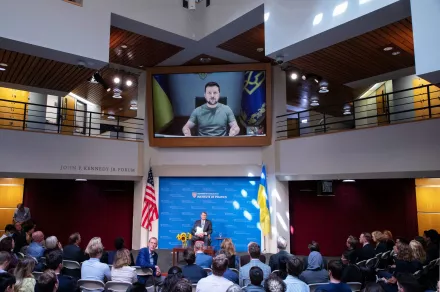 Volodymyr Zelensky on the big screen at the JFK Jr Forum with Ash Carter on stage.