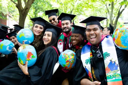 ELI Fellows post at Graduation with inflatable globes.