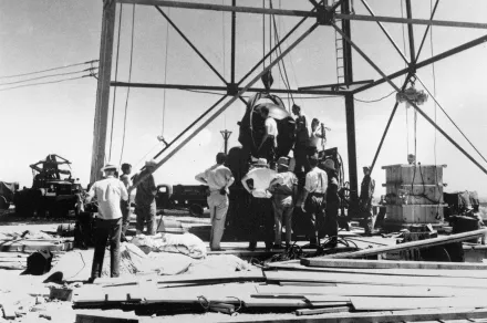 FILE - Scientists and other workers rig the world's first atomic bomb to raise it up onto a 100-foot tower at the Trinity Test Site near Alamogordo, N.M. The New Mexico site where the world’s first atomic bomb was detonated is expecting thousands of visitors Saturday due to the popularity of the movie, "Oppenheimer." Trinity Site, a designated National Historic Landmark, only opens to the public twice a year. (AP Photo/File )