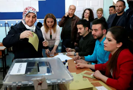 A Turkish woman casts her ballot at a polling station in Ankara, Turkey, Sunday, April 16, 2017.