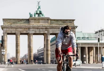 A bicyclist is seen near the Brandenburger Gate in Berlin, capital of Germany, March 28, 2020. 