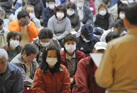 Residents of a nearby small town listen to government evacuation plan following Fukushima Dai-ichi nuclear meltdown