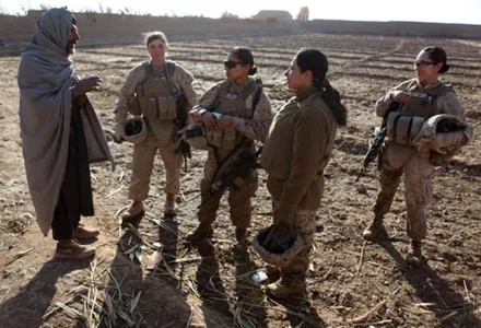U.S. Marines assigned to a female engagement team (FET) speak with a local Afghan man in his compound during a patrol in Marjah, Helmand province, Afghanistan, Dec. 30, 2010.
