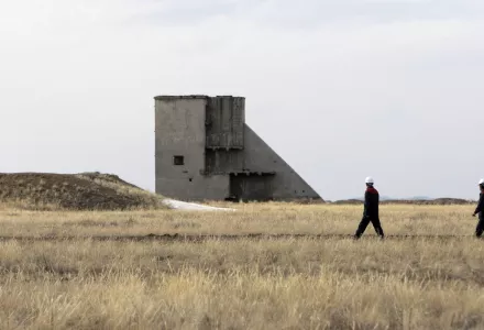 Workers pass a structure at the former Semipalatinsk nuclear bomb testing center, during a 2010 visit by U.N. Secretary General Ban Ki-moon, 90 miles (144 kilometers) from Kurchatov, Kazakhstan.