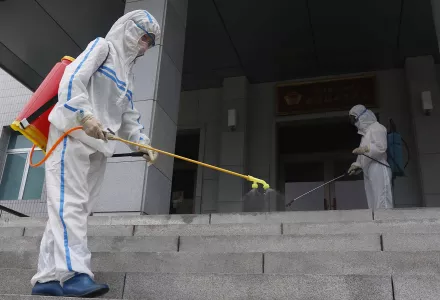 Staff of the Pyongyang Primary School No. 4 spray disinfectant in Pyongyang, North Korea, Wednesday, June 30, 2021. 