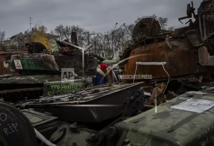 Women stand in front of a display of destroyed Russian tanks and armoured vehicles in downtown Kyiv, Ukraine, Monday, Nov. 7, 2022.