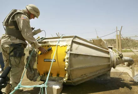 A U.S. soldier checks the radiation level of a canister found in Tuwaitha, 31 miles south of Baghdad. June 24, 2003.