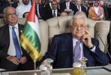 Palestinian Authority President Mahmoud Abbas, right, and Secretary General of the Palestinian Liberation Organization, Saeb Erekat attend the 30th Arab Summit in Tunisia in March 2019.