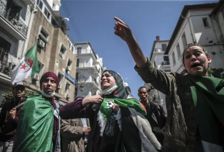 Women react after police attempted to disperse a demonstration for students in Algiers, Algeria, Tuesday, April 9, 2019. Algerian police used pepper spray and water cannons to break up a group of students protesting in the country's capital, less than an hour after the country's parliament chose an interim leader.
