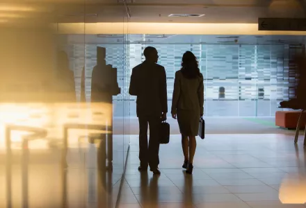 Silhouettes of two people speaking