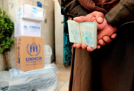 A displaced Iraqi man, who fled his town after the advance of Islamic militants in western Iraq, holds his family member's documents to present to staff of the United Nations refugee agency, UNHCR, distribution center, in an attempt to receive humanitarian assistance from them, in the Mansour district of Baghdad, Iraq, Tuesday, Feb. 24, 2015. 