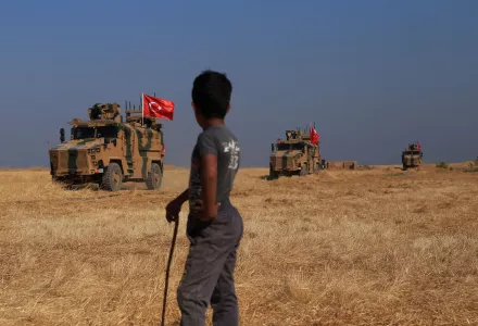 Turkish armored vehicles patrol as they conduct a joint ground patrol with American forces in the so-called "safe zone" on the Syrian side of the border with Turkey, near the town of Tal Abyad, northeastern Syria, Friday, Oct.4, 2019.