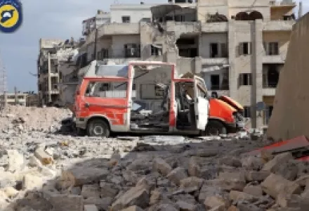 In this photo provided by the Syrian Civil Defense group known as the White Helmets, a destroyed ambulance is seen outside the Syrian Civil Defense main center after airstrikes in Ansari neighborhood in the rebel-held part of eastern Aleppo, Syria, Friday
