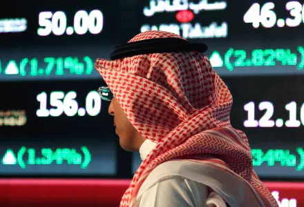 A Saudi man walks at the Tadawul Saudi Stock Exchange, in Riyadh, Saudi Arabia.