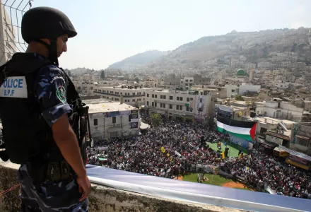 A Palestinian police officer watches a rally in support of the Palestinian bid for statehood recognition in the United Nations, in the West Bank city of Nablus.