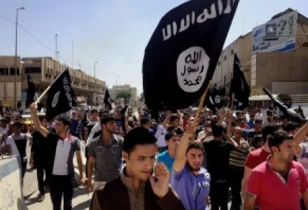 Demonstrators chant slogans to support al-Qaida-inspired Islamic State of Iraq and the Levant as they carry al-Qaida flags in front of the provincial government headquarters in Mosul, Iraq.