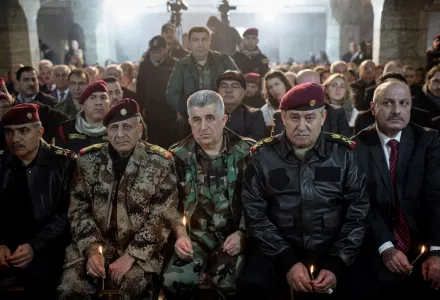 Iraqi Army and Peshmerga commanders attend Christmas Eve's Mass in the Assyrian Orthodox church of Mart Shmoni, in Bartella, Iraq, Saturday, December 24, 2016.
