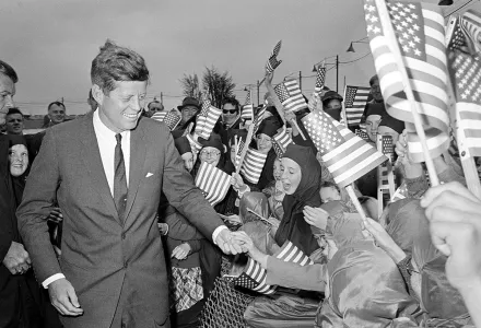 U.S. President John F. Kennedy is greeted by an enthusiastic crowd of children and nuns from the Convent of Mercy, as he arrives from Dublin by helicopter at Galway's sports ground, Ireland, June 29, 1963. (AP Photo)