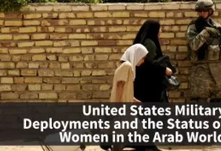 An Iraqi woman and girl pass a U.S. Army soldier as he patrols in the Shiite stronghold of Sadr City in Baghdad, Iraq.