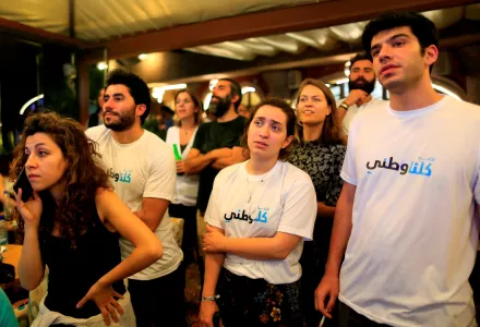 In this Sunday, May 6, 2018 photo, supporters and volunteers of the coalition Kulna Watani or (We are all Patriots) gather at a Beirut shisha cafe as they watch television ahead of an expected announcement of elections results in Beirut, Lebanon. 