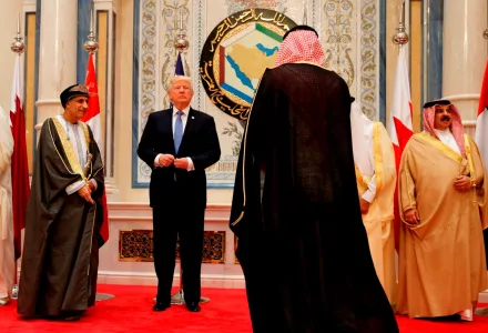 President Donald Trump adjusts his jacket before posing for photos with leaders at the Gulf Cooperation Council meeting, at the King Abdulaziz Conference Center, Sunday, May 21, 2017, in Riyadh.