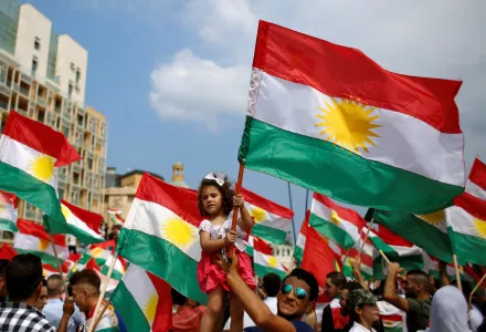 A man holds a girl waving a Kurdish flag as they gather to support next week's referendum in Iraq, at Martyrs Square in Downtown Beirut, Lebanon, Sunday, Sept. 17, 2017.