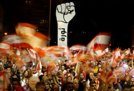 Anti-government protesters wave Lebanese flags during ongoing anti-government protests, in Beirut, Lebanon, Sunday, Nov. 10, 2019.